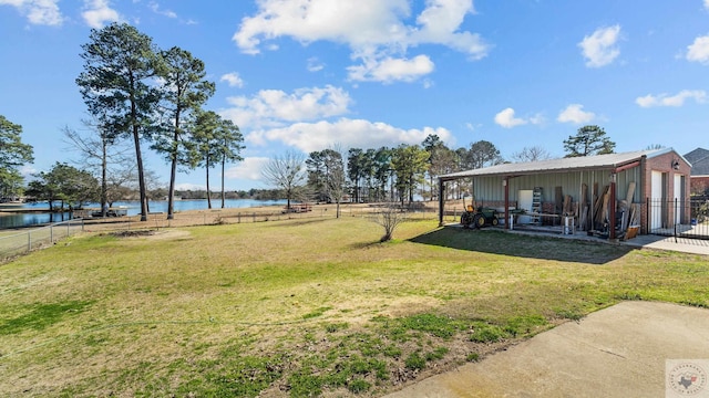 view of yard featuring a water view and a fenced backyard