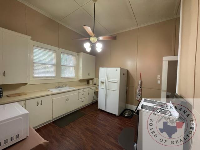 kitchen featuring crown molding, sink, white cabinets, white appliances, and dark hardwood / wood-style floors