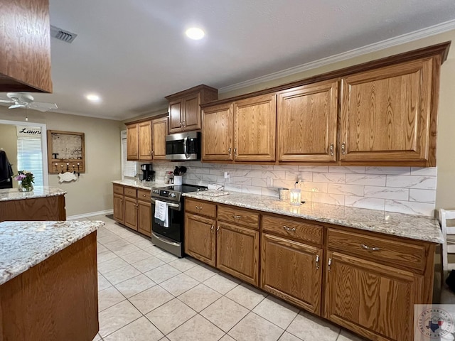 kitchen featuring light tile patterned floors, decorative backsplash, appliances with stainless steel finishes, brown cabinets, and ornamental molding