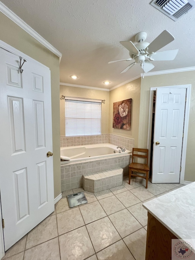 bathroom featuring a bath, ornamental molding, visible vents, and tile patterned floors