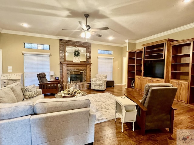 living room featuring crown molding, a fireplace, dark wood-style flooring, and a wealth of natural light