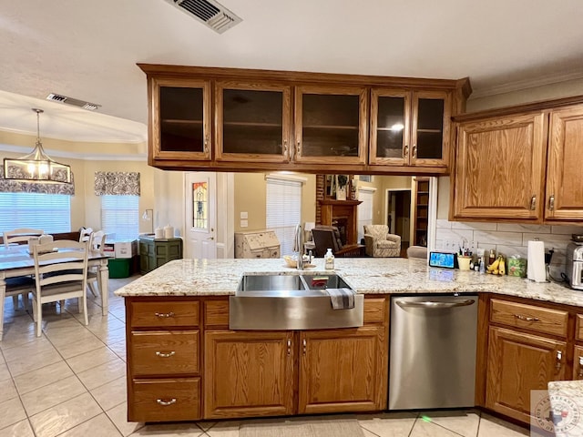 kitchen featuring visible vents, brown cabinetry, dishwasher, glass insert cabinets, and a sink