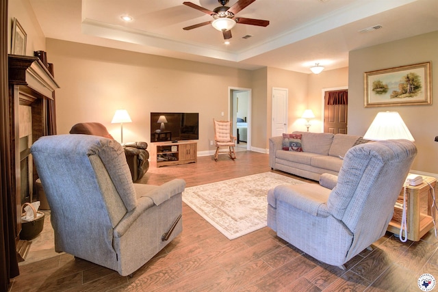 3705 Connie Ln, Texarkana, TX 75503 - living area featuring a raised ceiling, a ceiling fan, ornamental molding, dark wood-style floors, and recessed lighting