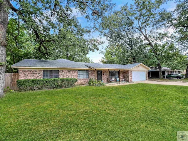 ranch-style home featuring a garage and a front yard