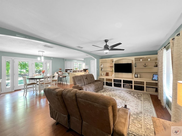 living room featuring ceiling fan and wood-type flooring