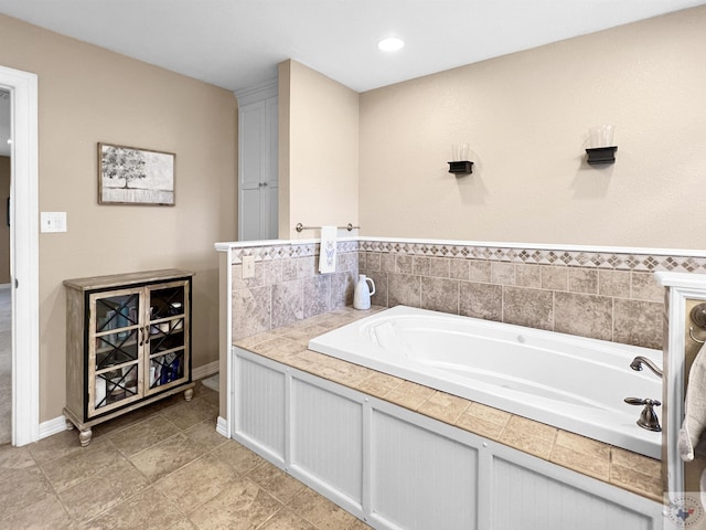 bathroom with a tub to relax in