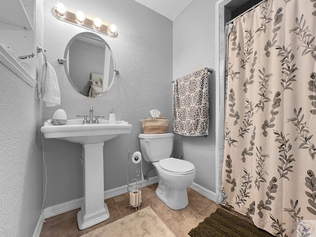 bathroom featuring toilet and a shower with curtain