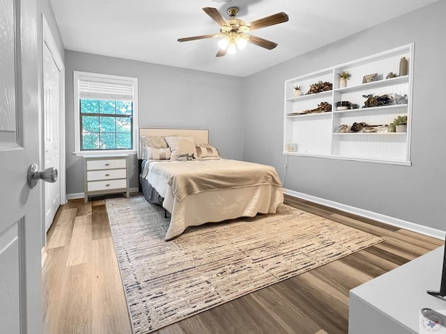 bedroom with ceiling fan and light hardwood / wood-style floors