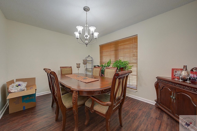 dining area with dark wood-type flooring and a chandelier