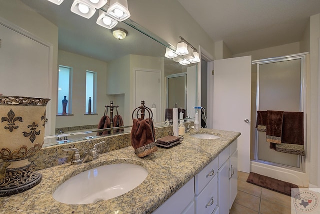 bathroom with tile patterned floors, walk in shower, and vanity