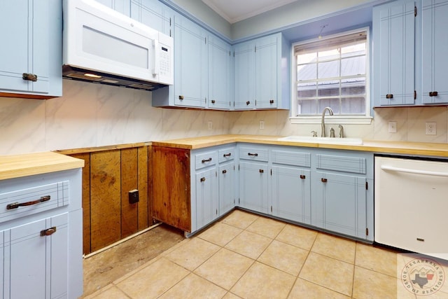 kitchen with blue cabinets, white appliances, a sink, light countertops, and backsplash