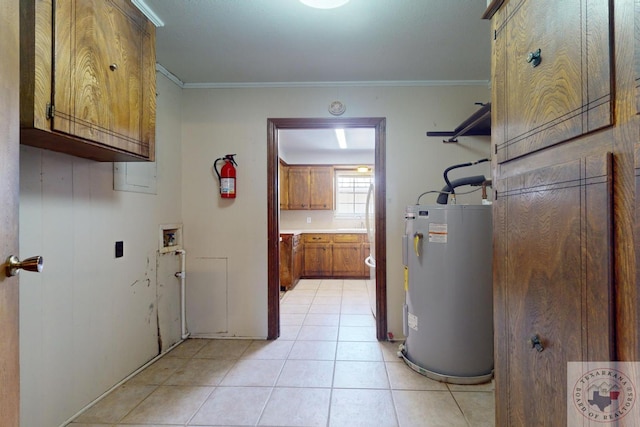 laundry room featuring washer hookup, crown molding, cabinets, and water heater