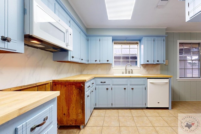 kitchen featuring butcher block counters, visible vents, ornamental molding, a sink, and white appliances