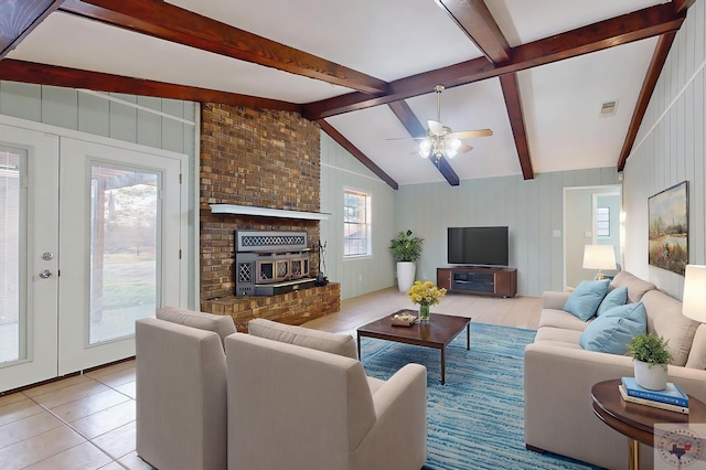 tiled living area featuring lofted ceiling with beams, visible vents, a ceiling fan, and french doors