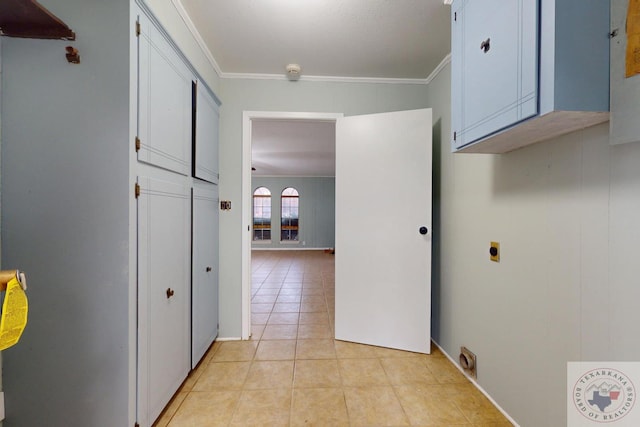 hall with light tile patterned flooring and crown molding