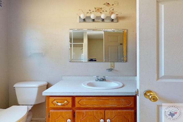 bathroom with vanity and toilet