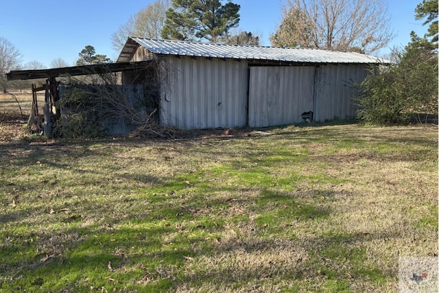 view of outdoor structure featuring a lawn