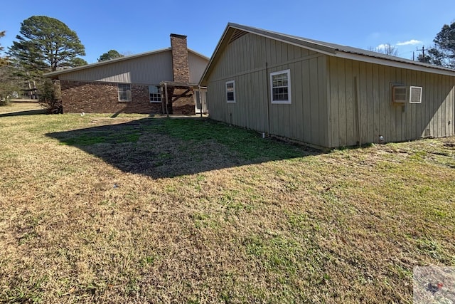 rear view of house featuring a yard