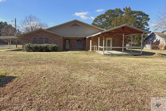 view of front of house with a front yard and a patio area