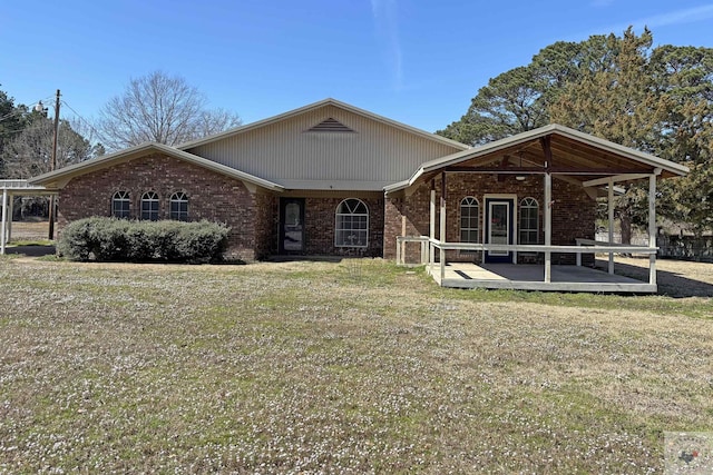 view of front facade with brick siding and a front lawn