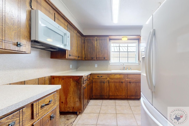 kitchen featuring white appliances, crown molding, tasteful backsplash, sink, and light tile patterned flooring