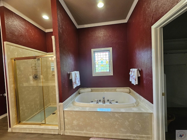 bathroom featuring crown molding and separate shower and tub