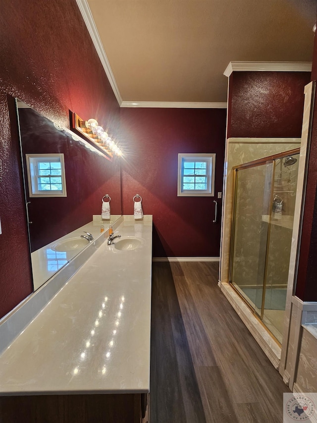 bathroom featuring hardwood / wood-style floors, vanity, walk in shower, and ornamental molding