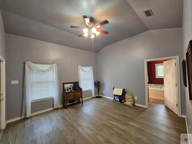 miscellaneous room with dark wood-type flooring, vaulted ceiling, and ceiling fan