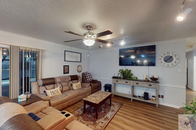 living room featuring hardwood / wood-style floors, a textured ceiling, ceiling fan, and ornamental molding