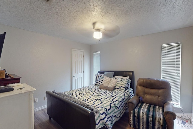 bedroom with a textured ceiling, dark hardwood / wood-style floors, and ceiling fan