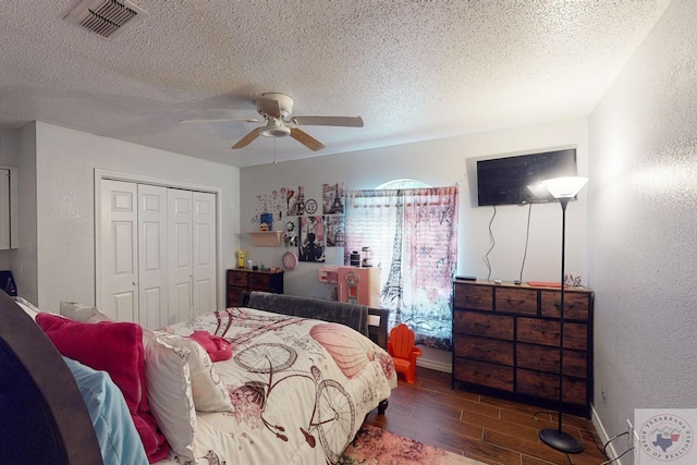 bedroom with a closet, ceiling fan, and a textured ceiling