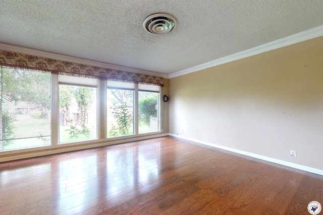 1315 Holloway Dr, Texarkana, TX 75503 - empty room featuring a textured ceiling, wood finished floors, and crown molding