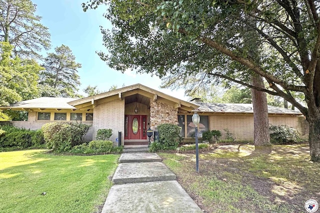 1315 Holloway Dr, Texarkana, TX 75503 - view of front facade featuring brick siding, a front yard, and a chimney