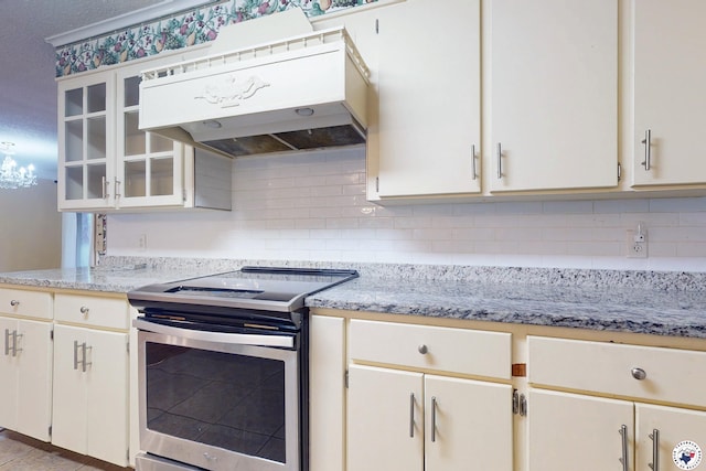 1315 Holloway Dr, Texarkana, TX 75503 - kitchen with electric range, ventilation hood, decorative backsplash, glass insert cabinets, and light stone counters