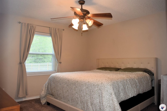 carpeted bedroom featuring baseboards and ceiling fan