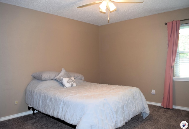 carpeted bedroom featuring a textured ceiling, baseboards, and ceiling fan