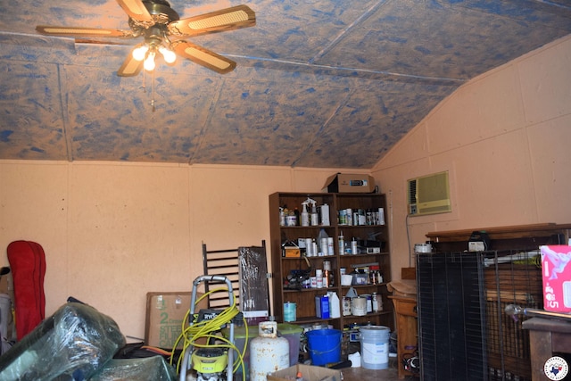 storage area with ceiling fan and a wall mounted AC