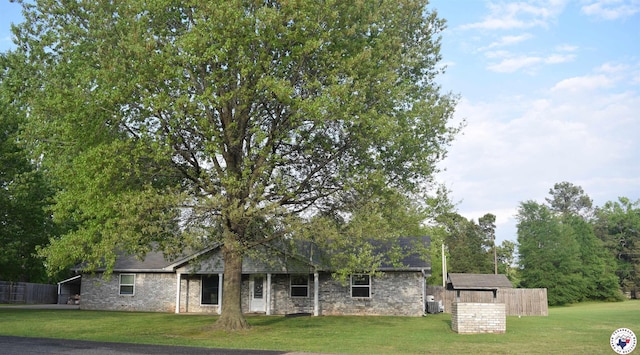 rear view of property featuring a lawn