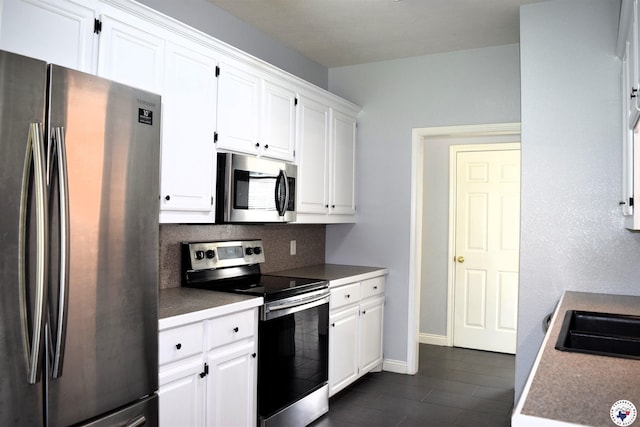 4802 David Dr, Texarkana, TX 75503 - kitchen with appliances with stainless steel finishes, white cabinetry, baseboards, and a sink