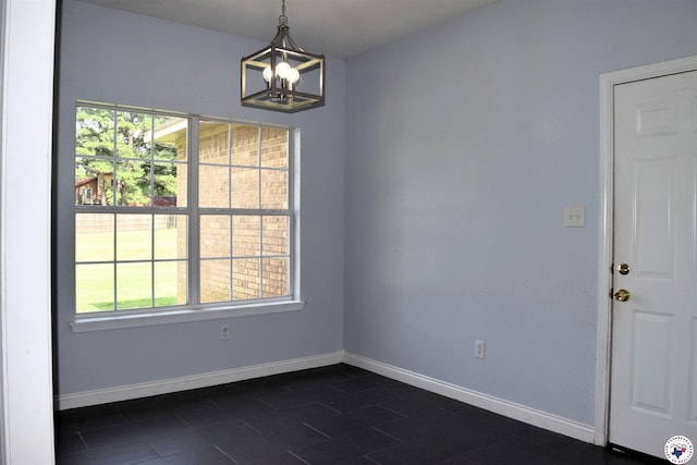 4802 David Dr, Texarkana, TX 75503 - unfurnished dining area featuring a chandelier, baseboards, and dark tile patterned floors