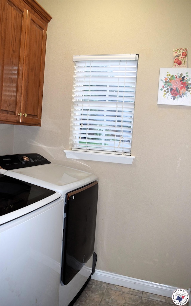 4802 David Dr, Texarkana, TX 75503 - laundry room featuring washing machine and dryer, cabinet space, and baseboards