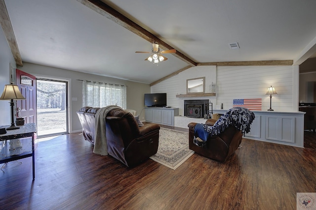 living room featuring ceiling fan, dark wood-type flooring, a large fireplace, and lofted ceiling with beams