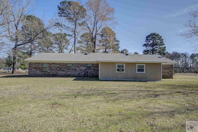 back of house with a lawn