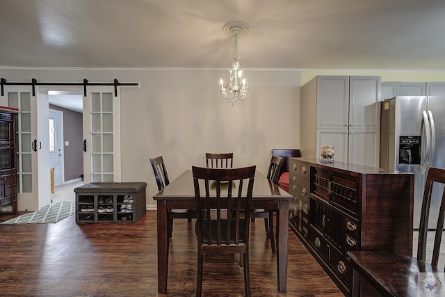 dining area with ornamental molding, dark hardwood / wood-style flooring, and a barn door