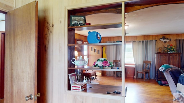 office space featuring light hardwood / wood-style flooring and wooden walls