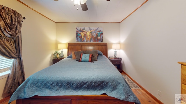 bedroom with ceiling fan, hardwood / wood-style floors, and ornamental molding