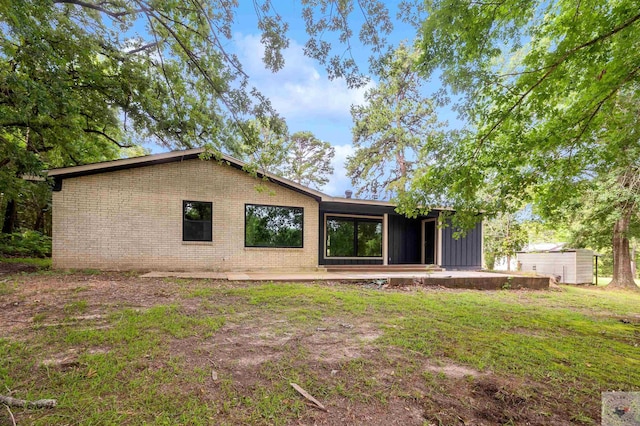 rear view of property with a yard and a patio