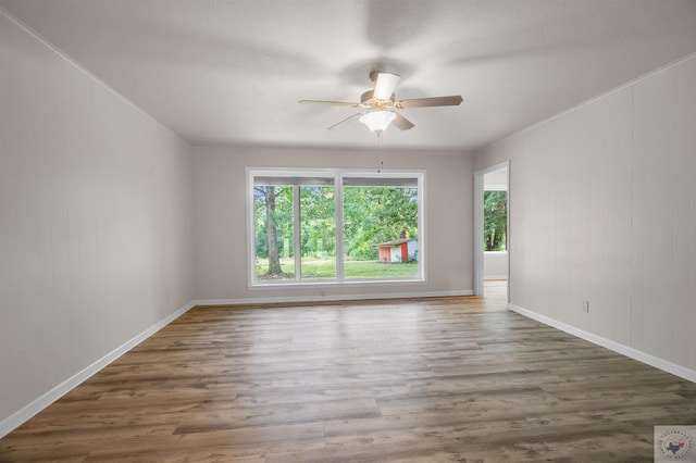 unfurnished room featuring dark hardwood / wood-style floors and ceiling fan