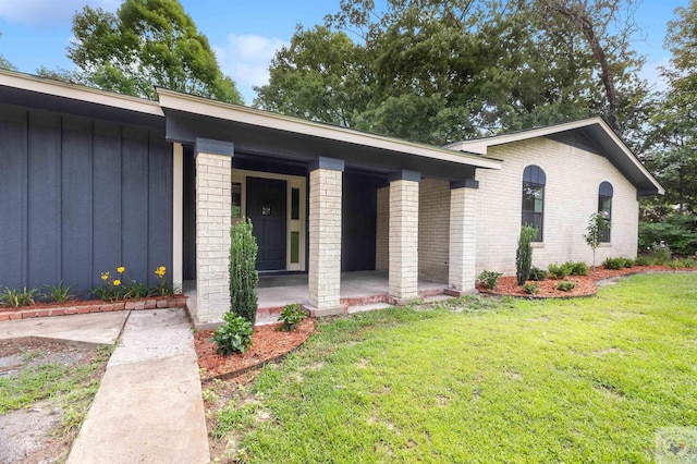 view of front of house with covered porch and a front lawn