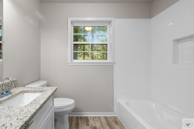 full bathroom with vanity, hardwood / wood-style flooring, bathing tub / shower combination, and toilet